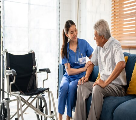 This is a picture of a nurse holding a elderly patient hand.